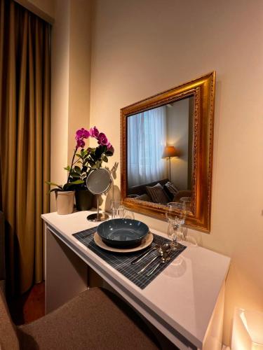 a room with a table with a mirror and glasses at 70 steps studio A, 50 meters from Dimokratias metro station in Thessaloniki