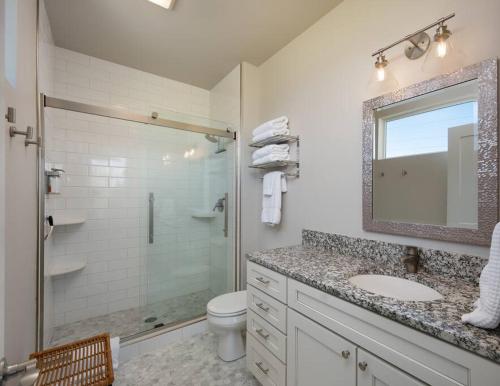 a bathroom with a shower and a sink and a toilet at Cinnabar Suite - Mountain Views in Bozeman