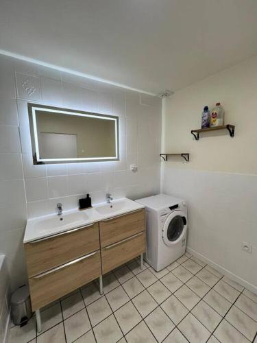 une salle de bain avec un lavabo et une machine à laver dans l'établissement Appartement spacieux 2 chambres 100m2 centre petite ville, à Longeville-lès-Saint-Avold