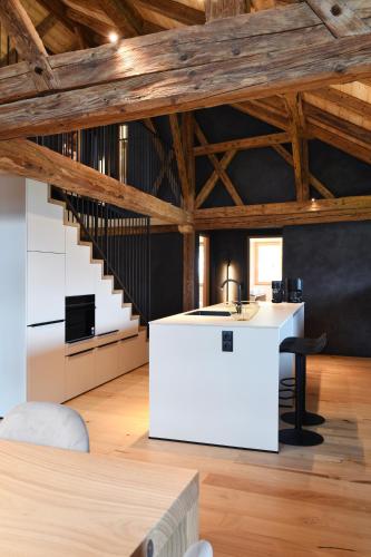 a room with a white counter and a staircase at Grieserhof Nals in Nalles