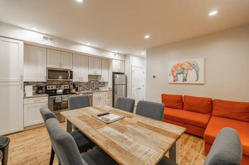 a living room with an orange couch and a table at Central LUX Apartment in DC in Washington, D.C.