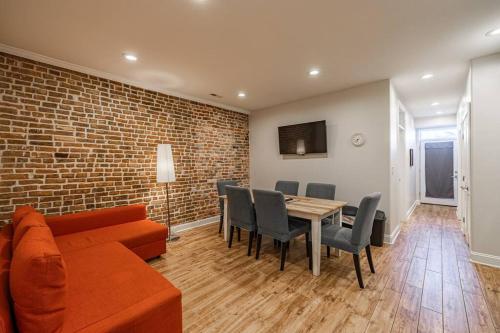 a living room with a couch and a table and chairs at Central LUX Apartment in DC in Washington, D.C.
