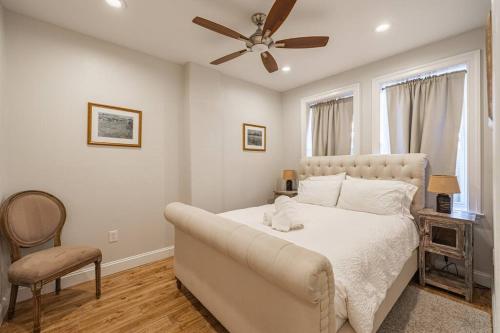a bedroom with a bed and a ceiling fan at Central LUX Apartment in DC in Washington, D.C.