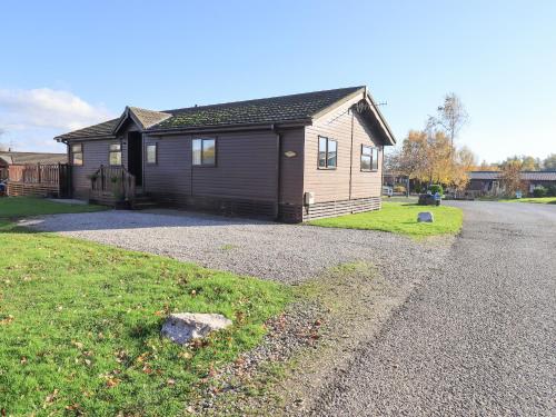 a small house on the side of a road at Kellet Lodge Lakeside 26 in Carnforth
