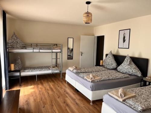 a bedroom with two beds and a bunk bed at Villa Altdorf in Ettenheim