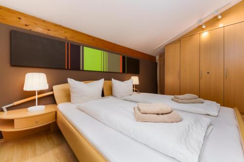 a bedroom with two beds and a tv on the wall at Haus Röcken in Dalaas