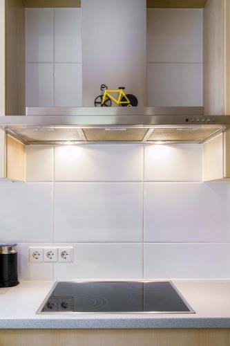 a kitchen with white cabinets and a stove at Haus Röcken in Dalaas