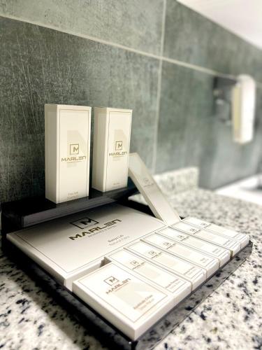 a pile of books sitting on a counter in a bathroom at Marlen Hotel Bayraklı in Bayrakli