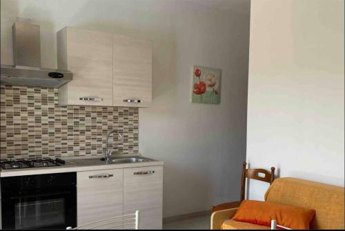 a kitchen with a sink and a stove top oven at Casa Relax in Gaggi
