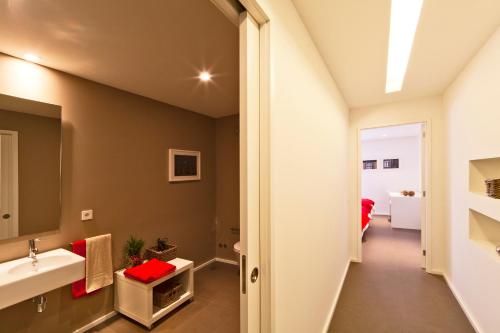 a bathroom with a sink and a mirror at bnapartments Palacio in Porto