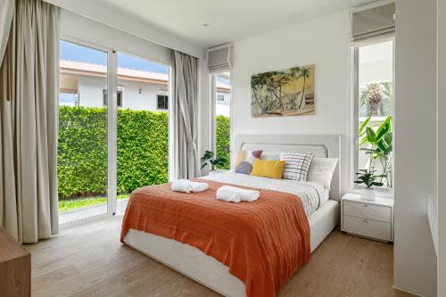 a bedroom with a bed with two towels on it at Friendly Kamala Garden View in Kamala Beach