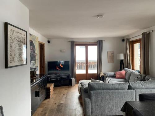 a living room with two couches and a television at Morzine apartment, perfect ski and summer base for 8 in Montriond