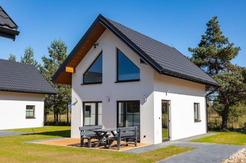 a house with a large number four at Domki Perła Dunajca - Hotel Perła Dunajca in Czarny Dunajec