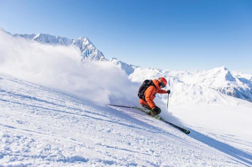a man is skiing down a snow covered mountain at Haus Röcken in Dalaas