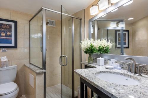 a bathroom with a shower and a toilet and a sink at The Georgetown Inn in Washington, D.C.