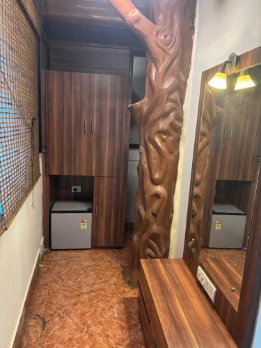 a dressing room with a wooden door and a mirror at Om Sai Villa Guesthouse in Kolkata