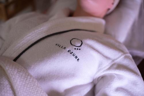 a small tattoo on the side of a white teddy bear at Villa Ozone in Sopot