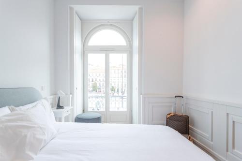 a white bedroom with a bed and a window at Boulevard Lisbon Bedrooms in Lisbon