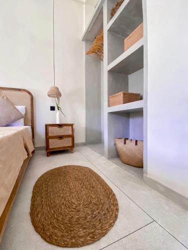 a bedroom with a bed and a rug on the floor at The Palm Private Cottages Midigama in Midigama