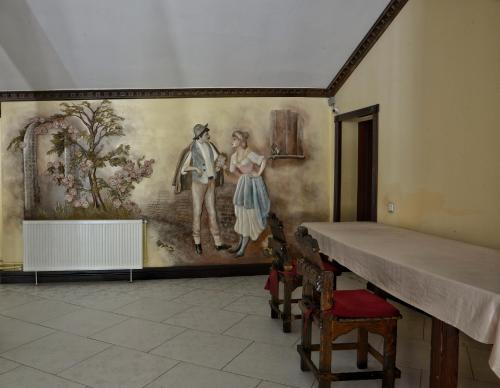 a painting on a wall in a room at Gotel Milenium in Mykulychyn