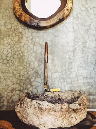 a stone tub in a bathroom with a window at Casa Selva casa privada con alberca, en Punta in Brisas de Zicatela