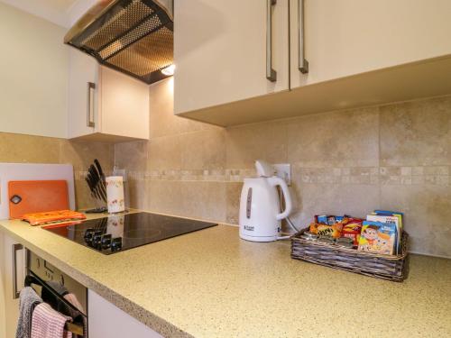 a kitchen with a counter top with a coffee maker at Oakleaves in Colchester