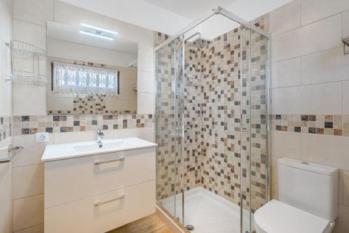 a bathroom with a shower and a sink and a toilet at Costa Adeje Heated Pool Marina Primavera in Adeje