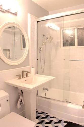 a white bathroom with a sink and a shower at Newly Furnished Pool House in Los Angeles