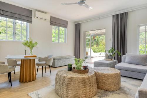 a living room with a couch and a table at Villa Coloniale Schumacher Luxury Retreat, Adults Only in Cape Town