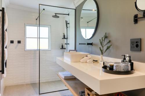 a bathroom with a sink and a mirror at Villa Coloniale Schumacher Luxury Retreat, Adults Only in Cape Town