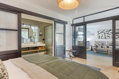 a bedroom with a large bed and a mirror at Villa Coloniale Schumacher Luxury Retreat, Adults Only in Cape Town