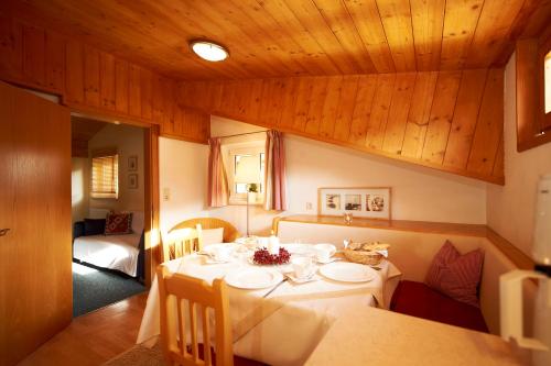 a dining room with a table and a couch at Appartementhaus Gratz in Wagrain