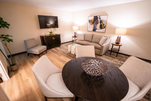 a living room with a table and chairs at Mai Hana Hotel- Intl Drive, Trademark Collection by Wyndham in Orlando