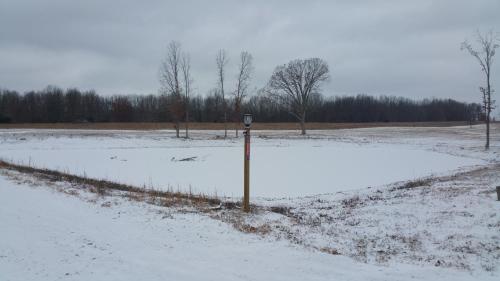 a field covered in snow with a pole in it at Cozy Cabin on 80 acres in The Ozarks, very unique! in West Plains
