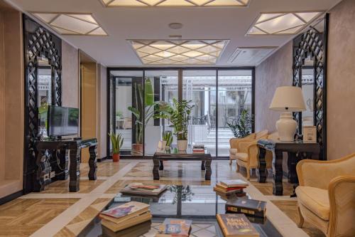 a living room with a couch and a table at Hotel President - Vintage Hotel in centro in Riccione