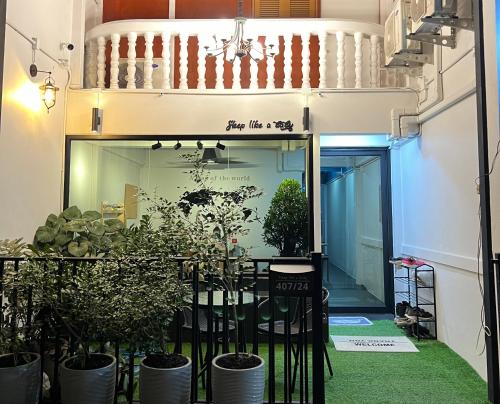 a corridor with potted plants in a building at Sleep like a baby Hostel Pattaya in Jomtien Beach