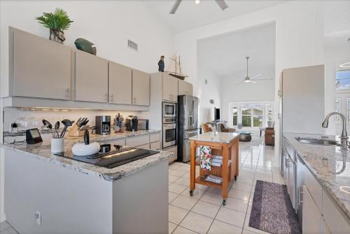 a kitchen with white cabinets and a counter top at 265 Belvedere in Punta Gorda
