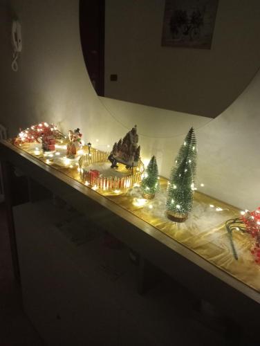a display of christmas lights and christmas trees on a table at Casa Vacanza Luna in Palagiano