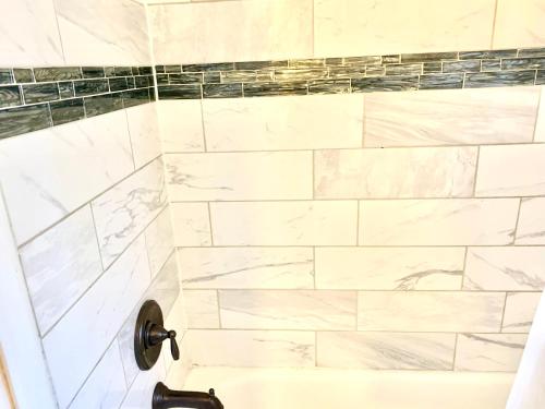 a bathroom with a shower with marble tiles at Near XAi Data Center-Project Pyramid-Medical District-Valero-Kellog in Memphis