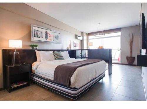 a bedroom with a large bed in a room at Recoleta - Elite 13th floor apt with rooftop pool in Buenos Aires