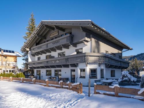 a building in the snow with a fence at Karwendel Berglodge in Leutasch