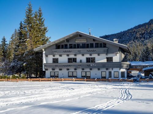 a large white building in the snow with trees at Karwendel Berglodge in Leutasch