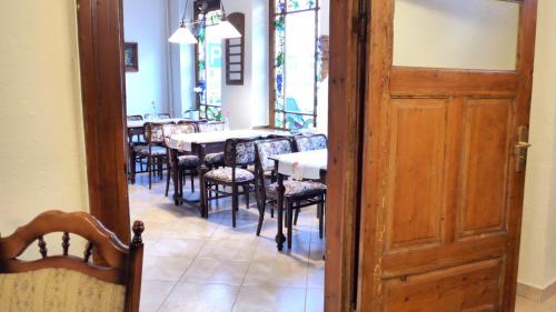 an open door to a dining room with tables and chairs at Romantisches Hotel Zur Traube Schwerin in Schwerin