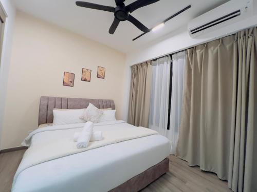 a bedroom with a large white bed with a ceiling fan at Agile TRX Luxury suite Bukit bintang in Kuala Lumpur