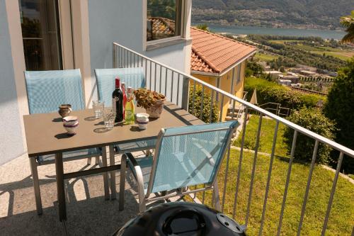 a table and chairs on the balcony of a house at Casa Teatro Panoramico 5 Star Holiday House in Locarno