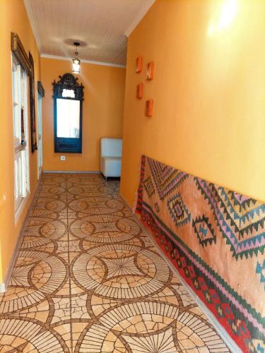 a hallway with a mosaic tile floor in a room at Guest House Ruh Achari in Sheki