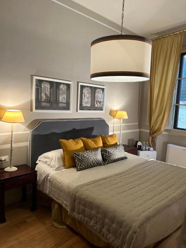 a bedroom with a large bed with two lamps at Residenza dei Pucci in Florence