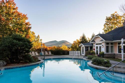 a swimming pool in front of a house at Nordic Village Condominium Resort in Jackson