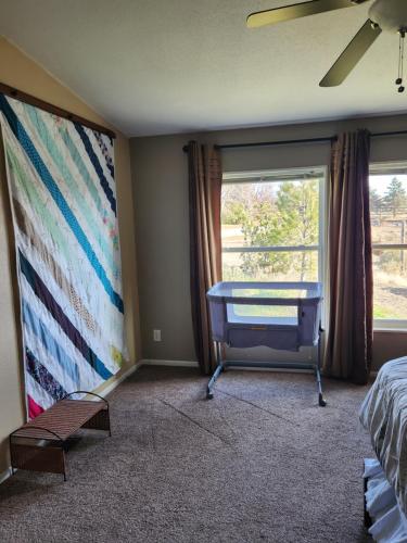 a bedroom with a table and a large window at Skyfire Ranch in Caldwell