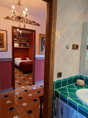 a bathroom with a tub and a sink and a bedroom at Casa Rural El Mirador de la Vega in Horche